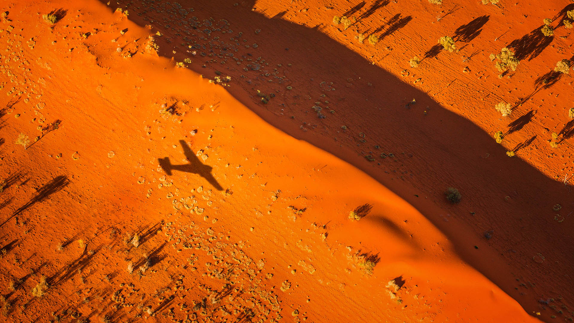 Airplane shadow over desert