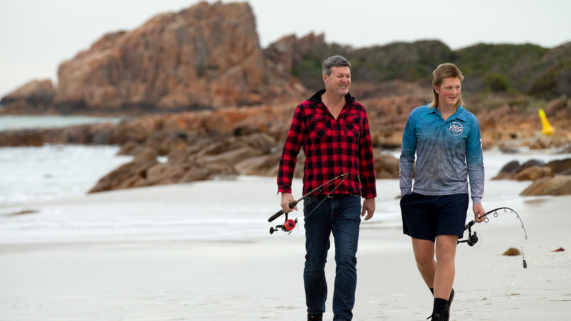 Two people walking on a beach