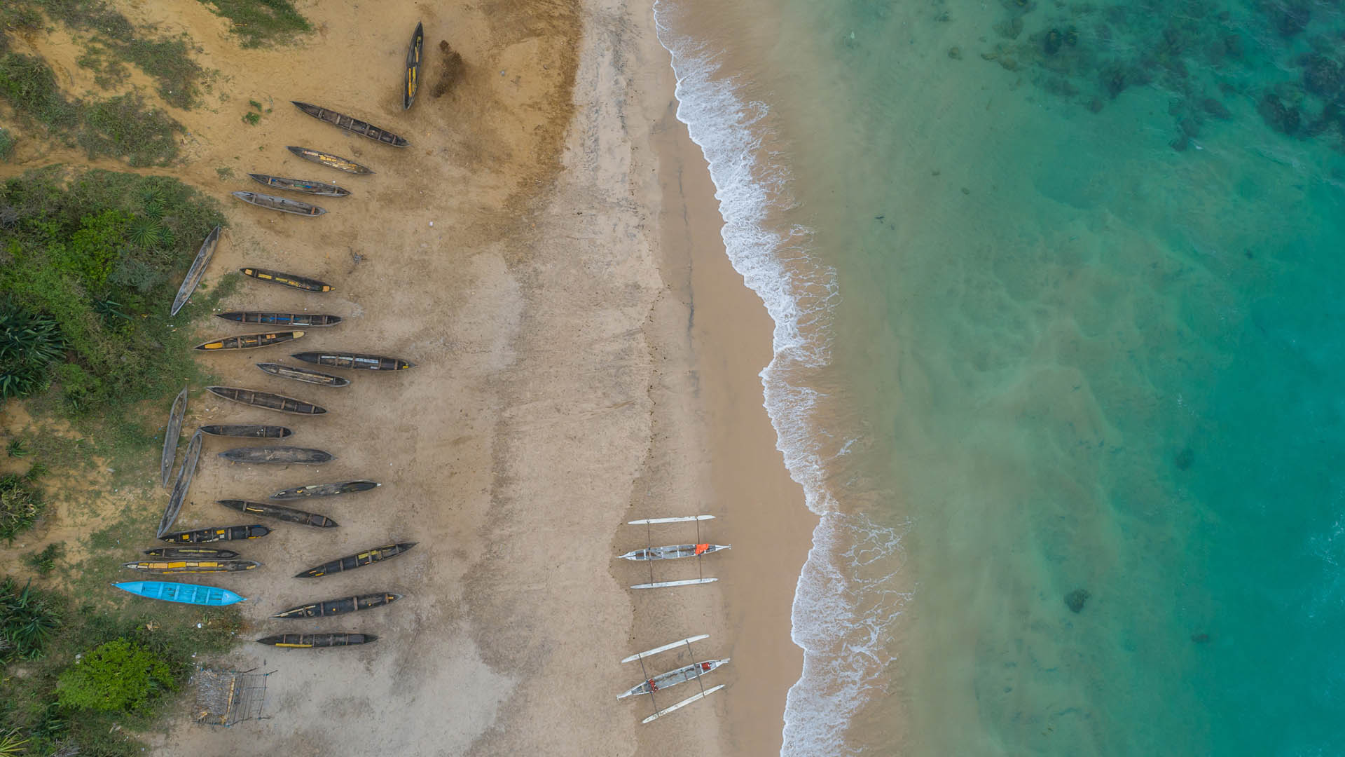 Canoes on the beach at QMM