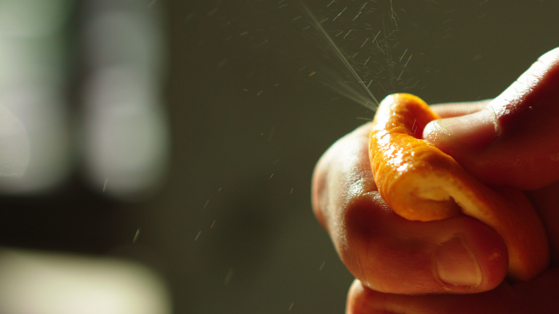 Orange slice being squeezed